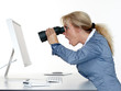 Shocked business woman searching with spyglass on the internet