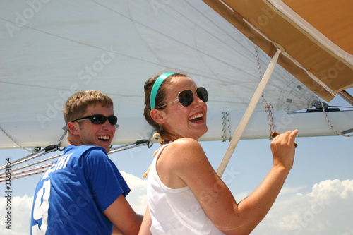 Photo: Two friends having fun on a sailboat Two friends having fun on a sailboat