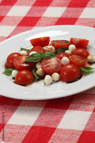 Photo: Caprese salad on table cloth Caprese salad on table cloth