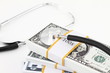 Dollar money on and stethoscope