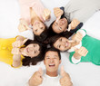 group of asian young people lying together with thumb up group of asian young people lying together with thumb up