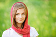 Woman in red headscarf smiles