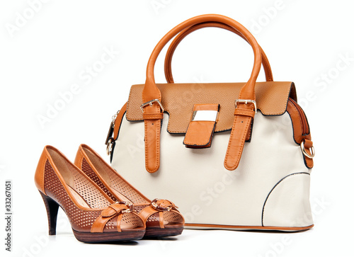 Photo: Pair of female shoes and handbag over white background Pair of female shoes and handbag over white background
