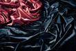 dark red and black glossy velvet is formative folds