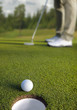 Golfer putting, selective focus on golf ball Golfer putting, selective focus on golf ball
