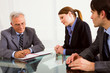two men and one woman during a job interview