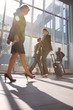 businessman and two businesswoman with trolley