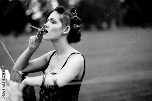 Photo: Housewife smoking a cigar after hanging clothes to dry Housewife smoking a cigar after hanging clothes to dry