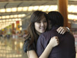 Asian Chinese female hugging friend at the airport Asian Chinese female hugging friend at the airport