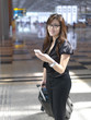 Asian Chinese female checking schedule at airport Asian Chinese female checking schedule at airport