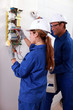 a young female electrician and man electrician