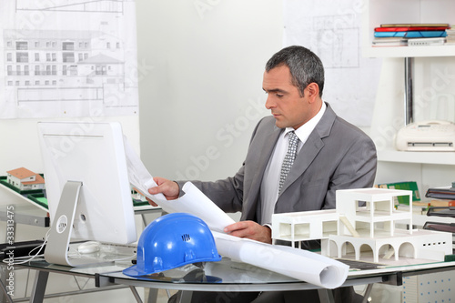 Photo: Architect looking at plans Architect looking at plans
