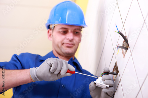 Photo: Electrician using screwdriver Electrician using screwdriver