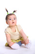 Baby girl sitting on the floor dressed