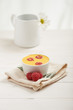 raspberry custard on a napkin, in background white flower