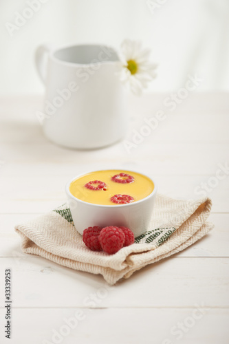 Photo: raspberry custard on a napkin, in background white flower raspberry custard on a napkin, in background white flower