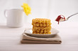 belgian waffles and ice cream in the dish on a white table