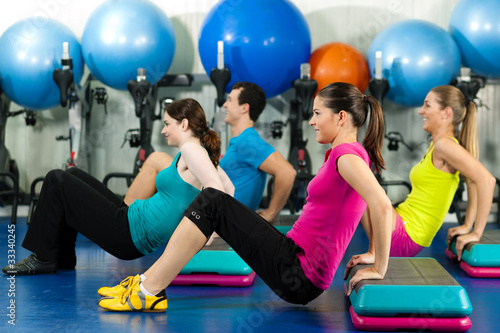 Photo: People in gym on step board People in gym on step board