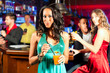 People with cocktails in bar or club