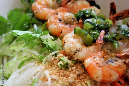 Photo: Grilled shrimp on bed of rice noodles and greens. Grilled shrimp on bed of rice noodles and greens.