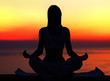 Yoga woman over sunset