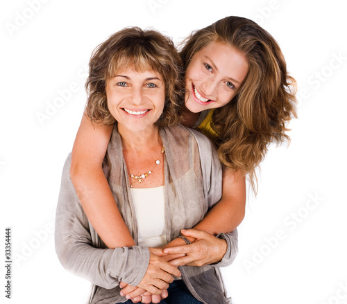 Photo: Pretty daughter hugging her mom from back Pretty daughter hugging her mom from back