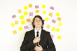 young businessman with postit reminder notes on the background young businessman with postit reminder notes on the background