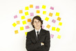 young businessman with postit reminder notes on the background young businessman with postit reminder notes on the background