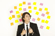young businessman with postit reminder notes on the background young businessman with postit reminder notes on the background