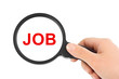 Magnifying glass in hand and word Job