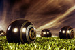 Photo: Close up of bowling balls on a bowling field at sunset Close up of bowling balls on a bowling field at sunset