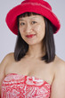 Photo: Aisan Woman in Red Cotton Hat and Top Smiling Aisan Woman in Red Cotton Hat and Top Smiling