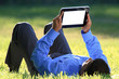 Foto: businessman with digital tablet laying down on grass businessman with digital tablet laying down on grass