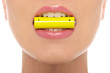 Woman holding battery in his mouth