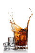 splash of cola in glass with ice cubes isolated on white