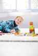 Happy little boy playing with cubes