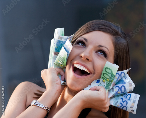 Photo: Beautiful ecstatic young woman with Euro bills Beautiful ecstatic young woman with Euro bills
