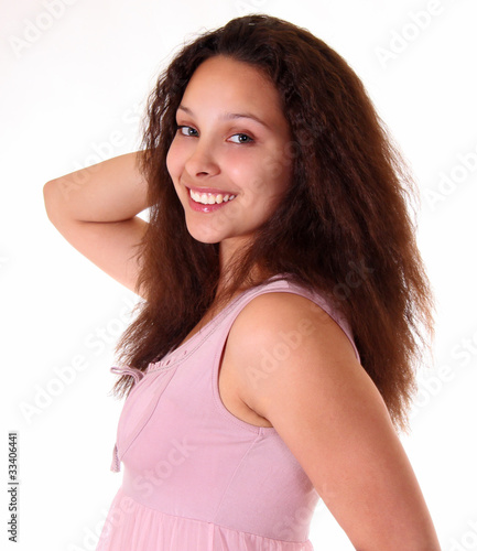 a young chubby girl in pink dress looking and smiling