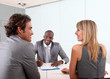 Couple meeting businessman in office Couple meeting businessman in office