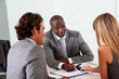Couple meeting businessman in office Couple meeting businessman in office
