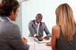 Couple meeting businessman in office Couple meeting businessman in office