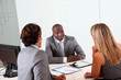 Couple meeting businessman in office