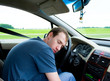 The man sleeps in the car The man sleeps in the car