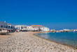 Beach with pebbles and  Mykonos church