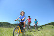 Family on a mountain bike ride in summer Family on a mountain bike ride in summer