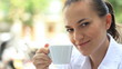 Attractive woman drinking coffee and smiling, steadicam shot