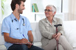 Senior woman talking to a young medic