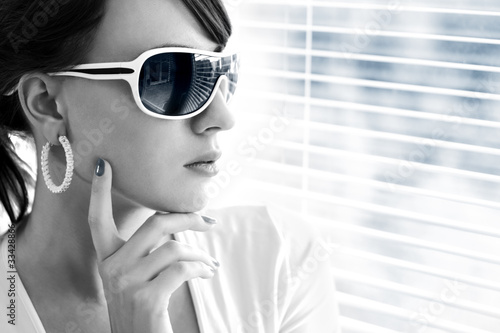 Photo: Young woman wearing sunglasses Young woman wearing sunglasses