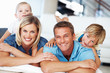 Couple with kids relaxing at home