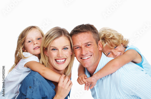 Photo: Couple smiling with two adorable children Couple smiling with two adorable children